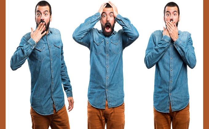 A man in a deffirent sign showcasing marketing mistakes with his hands covering his face.