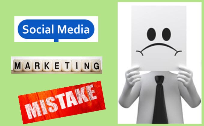 A man smile a piece of paper and holding up a sign that says social media marketing mistake.