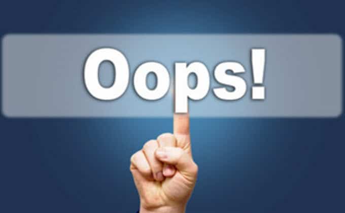 A hand is pointing at a button with an Oops mistake.