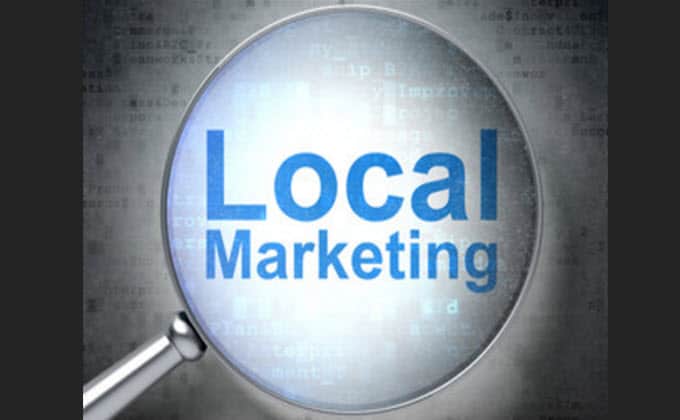 A magnifying glass highlighting the words local marketing.