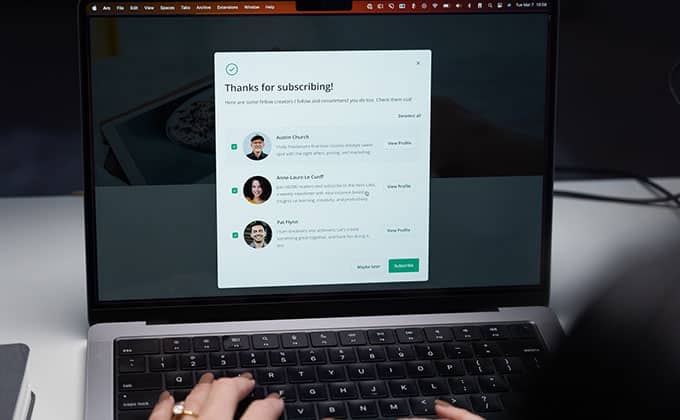 A person typing on a laptop with a contact form on the screen and profitable automated email sequences.