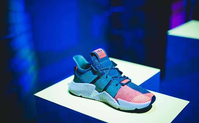 A sneakers on display in a dim-lit room, ready to captivate social media users and drive sales for a small business.